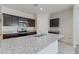 This kitchen features a large island with a sink, granite countertops, stainless appliances, and dark cabinets at 1314 W Kennedy Ave, Coolidge, AZ 85128