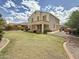 Spacious backyard featuring a large lawn, covered patio, and well-maintained landscaping; ideal for outdoor activities at 1350 E Racine Dr, Casa Grande, AZ 85122
