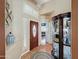 Inviting foyer with decorative tile floor, stylish light fixture, and elegant display cabinet at 1350 E Racine Dr, Casa Grande, AZ 85122