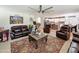 Open-concept living room with leather furniture, large area rug, and staircase to the second floor at 1350 E Racine Dr, Casa Grande, AZ 85122