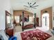 Spacious main bedroom with a four-poster bed, large fan, and neutral-toned decor at 1350 E Racine Dr, Casa Grande, AZ 85122