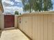 Side yard storage shed with a rustic gate; perfect for gardening or hobbies at 1350 E Racine Dr, Casa Grande, AZ 85122
