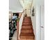Hardwood staircase with white banister leads to the upper level, accented with artistic decor at 1350 E Racine Dr, Casa Grande, AZ 85122