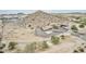 An aerial view of a beautiful house situated in a desert landscape with mountains in the background at 1421 W Rylie Ct, Queen Creek, AZ 85144