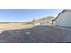 Desert landscaped backyard with a graveled ground cover and outdoor seating area at 1421 W Rylie Ct, Queen Creek, AZ 85144