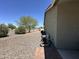 Property with a large backyard featuring desert landscaping, mature trees and privacy at 1421 W Rylie Ct, Queen Creek, AZ 85144