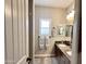 Bathroom with double sinks, granite counters, framed mirrors, shutters, and neutral paint at 1421 W Rylie Ct, Queen Creek, AZ 85144