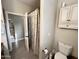 Neutral colored bathroom with a toilet, white vanity, and shower with patterned curtain at 1421 W Rylie Ct, Queen Creek, AZ 85144