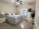 Cozy bedroom featuring a comfortable bed, white furniture, and natural light from the shuttered window at 1421 W Rylie Ct, Queen Creek, AZ 85144