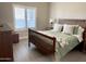 Bedroom with a bed, wood furniture, shutters, and neutral colored walls at 1421 W Rylie Ct, Queen Creek, AZ 85144