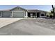 Charming single story home featuring a two car garage, desert landscaping, and a covered front porch at 1421 W Rylie Ct, Queen Creek, AZ 85144