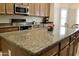 Spacious kitchen featuring an island with granite countertops and stainless steel appliances at 1421 W Rylie Ct, Queen Creek, AZ 85144