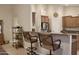 Eat-in kitchen with breakfast bar seating, stainless steel appliances, and granite countertops at 1421 W Rylie Ct, Queen Creek, AZ 85144