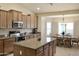 Modern kitchen featuring stainless steel Bosch appliances, an island, and an eat-in area at 1421 W Rylie Ct, Queen Creek, AZ 85144