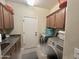 Well-equipped laundry room with cabinetry, granite counters, stainless steel washer and dryer at 1421 W Rylie Ct, Queen Creek, AZ 85144