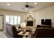 Comfortable living room with a fireplace, ceiling fan, and recessed lighting at 1421 W Rylie Ct, Queen Creek, AZ 85144