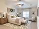 Serene main bedroom with a large bed, stylish decor, ceiling fan, and natural light, creating a peaceful retreat at 1421 W Rylie Ct, Queen Creek, AZ 85144