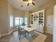 Home office with custom built-ins, a spacious desk, and bright natural light for a productive workspace at 1421 W Rylie Ct, Queen Creek, AZ 85144