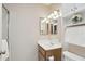 Well lit bathroom with single vanity, and overhead storage, complete with a shower behind a sliding glass door at 14300 W Bell Rd # 145, Surprise, AZ 85374
