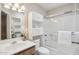 Bright bathroom featuring overhead storage, a glass enclosed shower, and a modern single vanity at 14300 W Bell Rd # 145, Surprise, AZ 85374