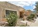 Inviting home exterior with a covered front porch and easy-care desert landscaping at 14300 W Bell Rd # 145, Surprise, AZ 85374