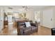 Warm and inviting living room with wood floors, connecting to the open kitchen and dining space at 14300 W Bell Rd # 145, Surprise, AZ 85374