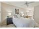 Bright main bedroom featuring a ceiling fan, and ensuite bath with modern cabinets and plenty of counter space at 14300 W Bell Rd # 145, Surprise, AZ 85374