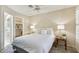 Bright main bedroom featuring a ceiling fan and an ensuite bathroom with a walk-in closet at 14300 W Bell Rd # 145, Surprise, AZ 85374