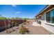 Well-maintained backyard featuring a colorful garden and spacious patio area at 14637 W Wethersfield Rd, Surprise, AZ 85379