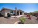 Landscaped backyard featuring a paved patio area, grill, and rock garden at 14637 W Wethersfield Rd, Surprise, AZ 85379