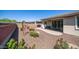 A beautiful backyard with a covered patio and lush landscaping at 14637 W Wethersfield Rd, Surprise, AZ 85379