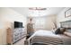 An inviting bedroom with a stylish bed, dresser, nightstand, and natural light at 14637 W Wethersfield Rd, Surprise, AZ 85379