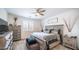 Comfortable bedroom with an oversized bed, dresser, nightstand, and ceiling fan at 14637 W Wethersfield Rd, Surprise, AZ 85379
