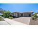 Charming single-story home with a well-manicured lawn and a spacious driveway at 14637 W Wethersfield Rd, Surprise, AZ 85379