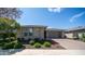 Inviting single-story home featuring stone accents and lush landscaping at 14637 W Wethersfield Rd, Surprise, AZ 85379