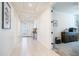 Inviting hallway with tile flooring, neutral walls, and a glimpse into adjacent rooms at 14637 W Wethersfield Rd, Surprise, AZ 85379
