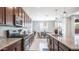 A modern kitchen with stainless steel appliances and a view of the dining area at 14637 W Wethersfield Rd, Surprise, AZ 85379
