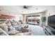 Open-concept living room with a sectional sofa and a view of the backyard patio at 14637 W Wethersfield Rd, Surprise, AZ 85379