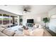 Spacious living room featuring a plush sectional sofa and sliding glass doors to a patio at 14637 W Wethersfield Rd, Surprise, AZ 85379