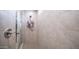 An expansive shower featuring tiled walls, glass door, and recessed lighting at 14637 W Wethersfield Rd, Surprise, AZ 85379