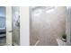 An expansive shower featuring tiled walls, glass door, and recessed lighting at 14637 W Wethersfield Rd, Surprise, AZ 85379