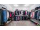 Spacious walk-in closet with ample hanging space, shelving, and carpeting at 14637 W Wethersfield Rd, Surprise, AZ 85379