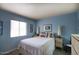 Comfortable bedroom with blue walls, a large window, and neutral carpeting at 15601 N 27Th St # 37, Phoenix, AZ 85032