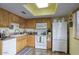 Functional kitchen featuring light wood cabinetry, white appliances, and a bright skylight at 15601 N 27Th St # 37, Phoenix, AZ 85032