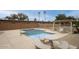 Community pool surrounded by desert landscaping, seating, and palm trees at 15601 N 27Th St # 37, Phoenix, AZ 85032
