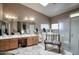 Bathroom with double vanity, tub, and walk-in shower offering a spa-like experience at 16112 W Whitton Ave, Goodyear, AZ 85395