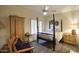 Bedroom with four poster bed, neutral colored walls, and soft carpet at 16112 W Whitton Ave, Goodyear, AZ 85395