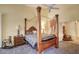 Bedroom featuring a grand four-poster bed, complemented by elegant side tables and lamps at 16112 W Whitton Ave, Goodyear, AZ 85395
