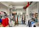 Walk-in closet with ample shelving, hanging rods, and organized storage solutions at 16112 W Whitton Ave, Goodyear, AZ 85395