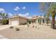 Charming desert home with two-car garage, xeriscaping, and a decorative tile roof at 16112 W Whitton Ave, Goodyear, AZ 85395